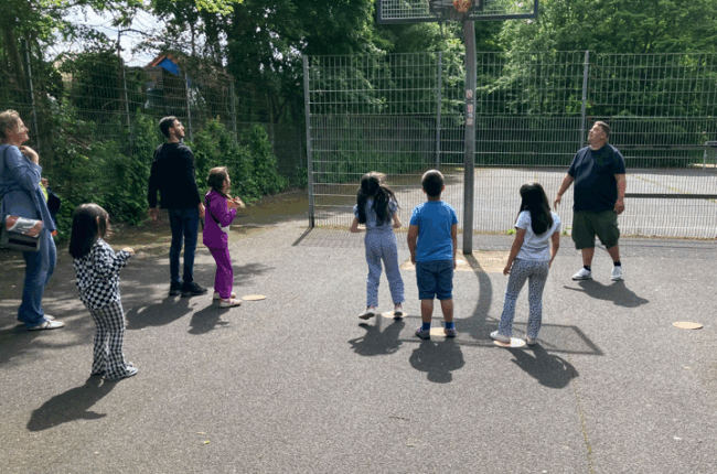 Kinder spielen Basketball auf der alten Fläche bei der Beteiligung